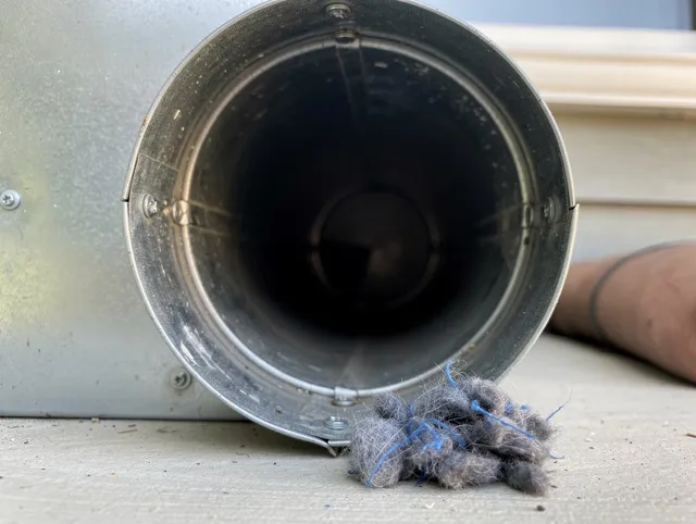 North Ridgeville Dryer Vent Cleaning technician using specialized equipment to clear severe dryer vent blockage in North Ridgeville